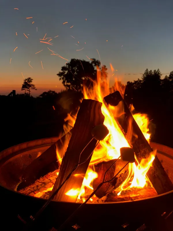 Lit fire pit against the sunset